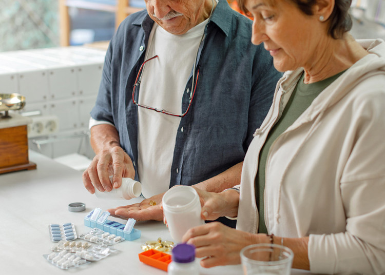 Couple in the kitchen organizing pills