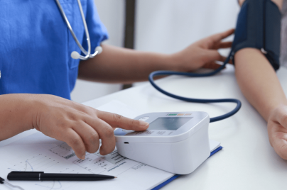 Medical Professional Checking Patient Blood Pressure.png