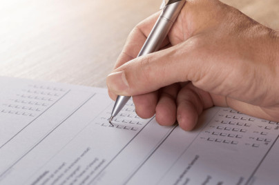 Person Filling Out A Survey Form