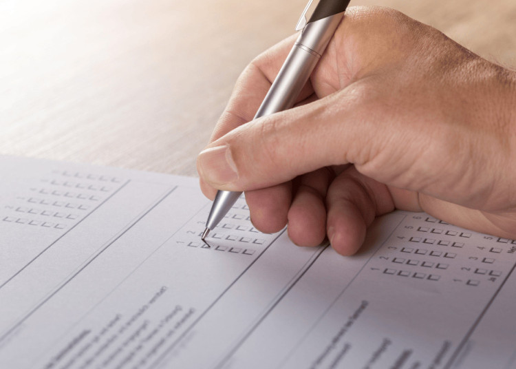 Person Filling Out A Survey Form